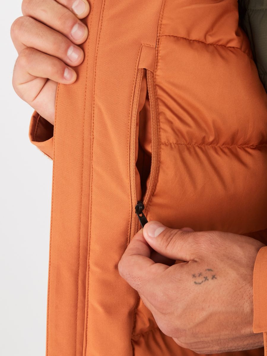 close up of side pocket on an orange mens puffer jacket