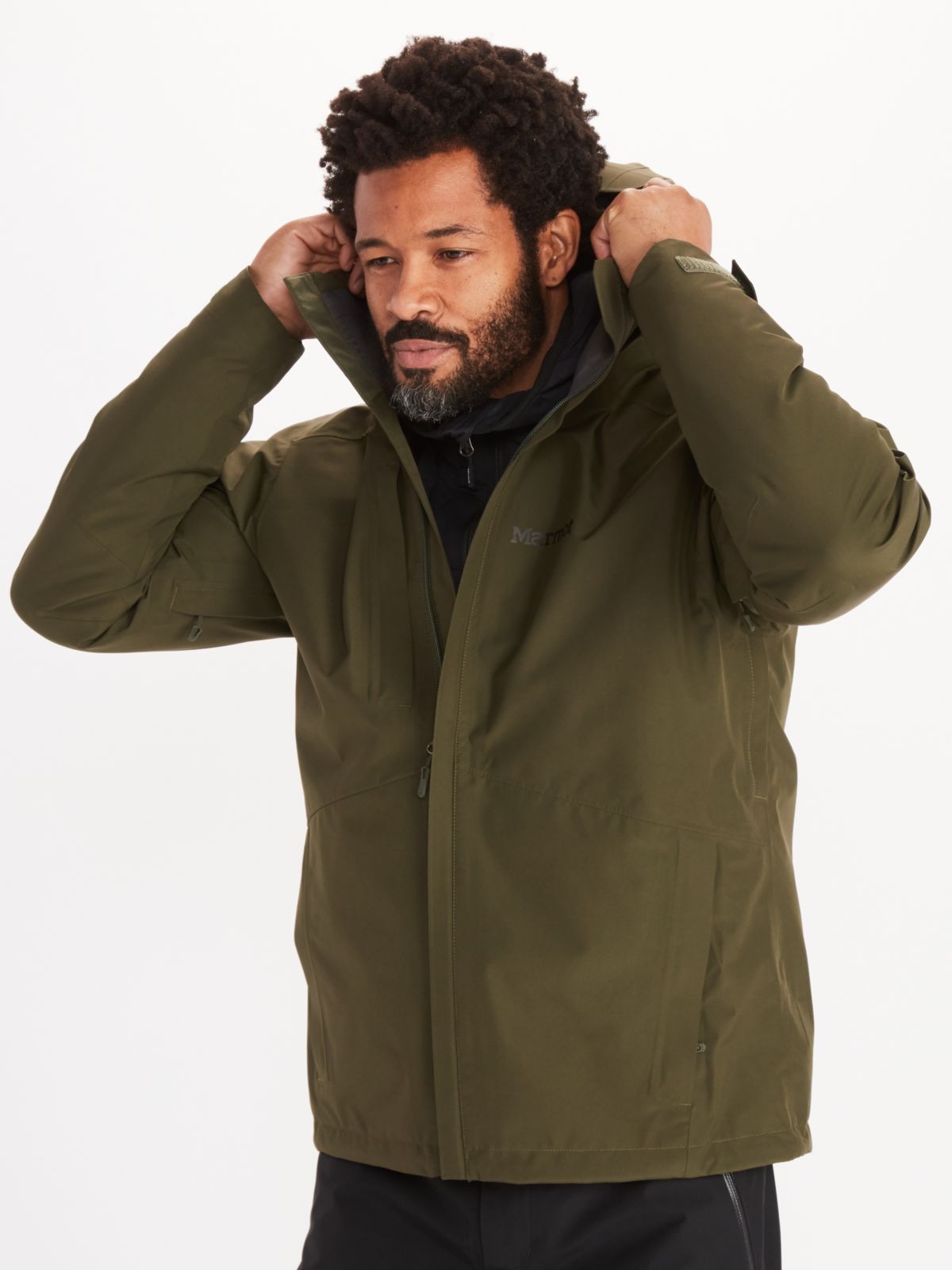 man modeling hood of minimalist jacket in nori