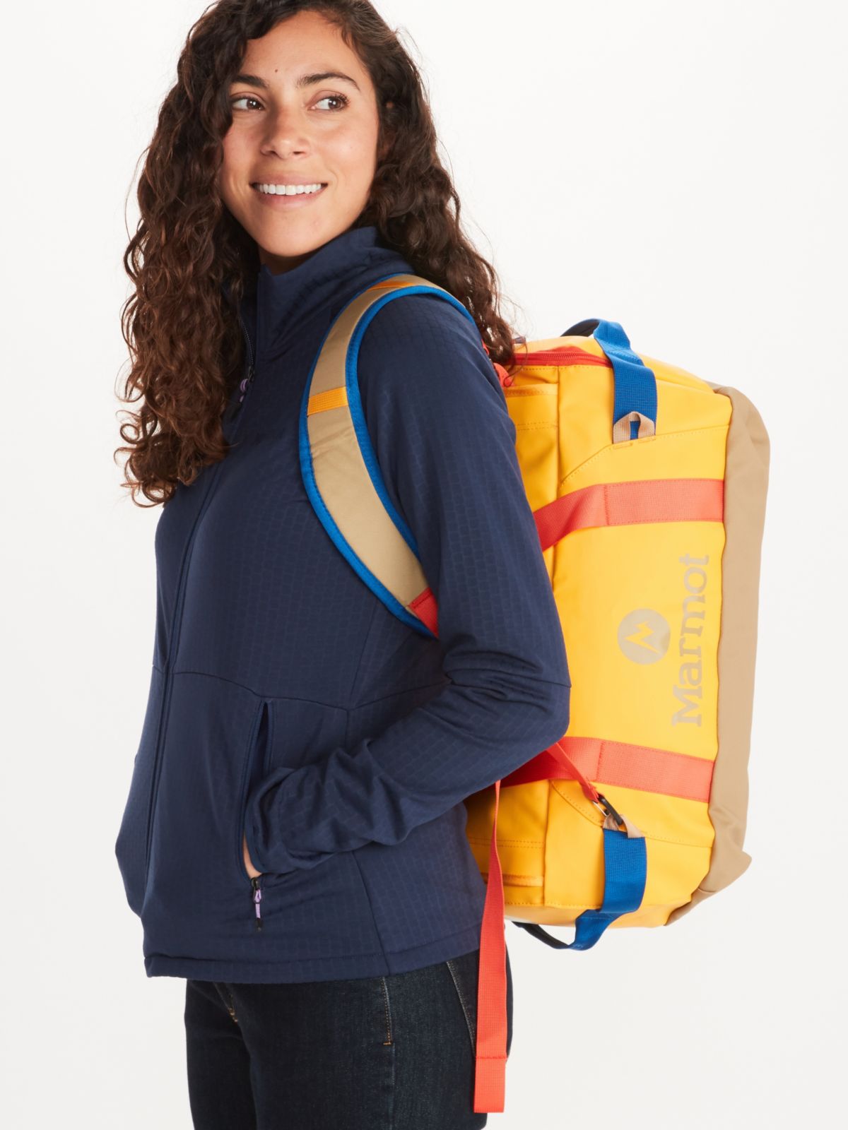 woman carrying long hauler duffle bag as a backpack