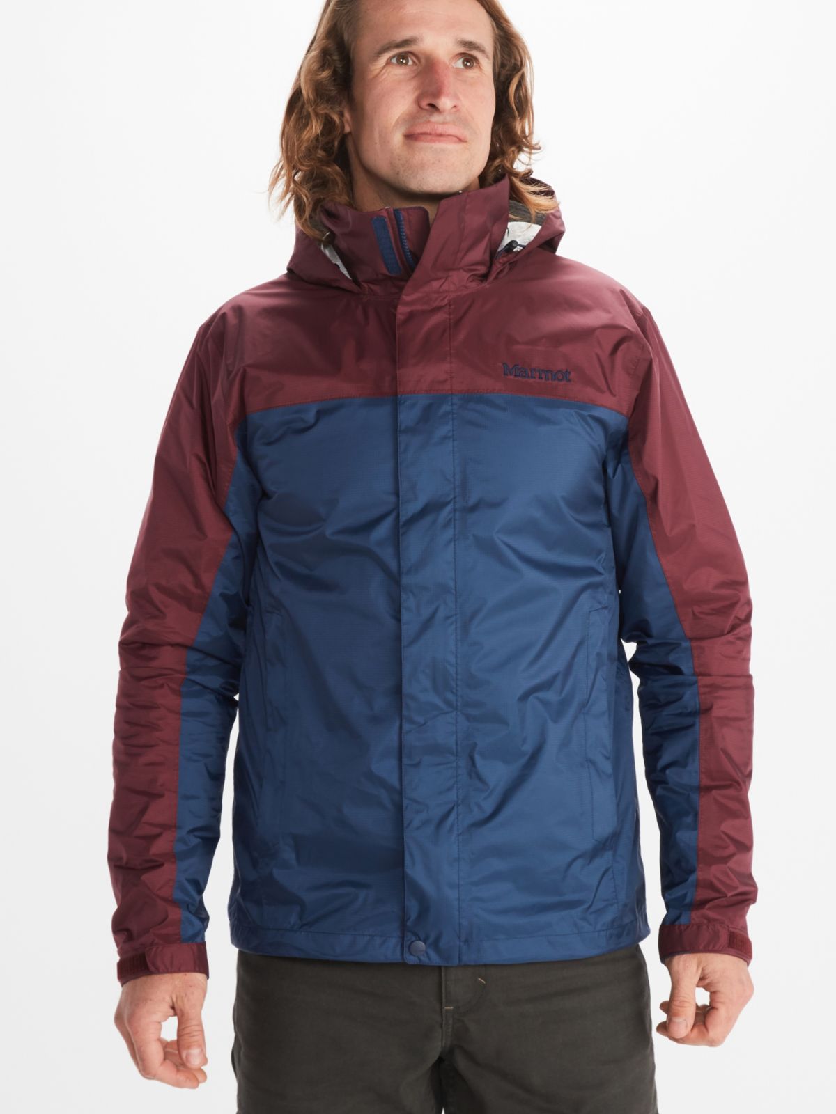 Model wears Marmot mens rain jacket in red and blue