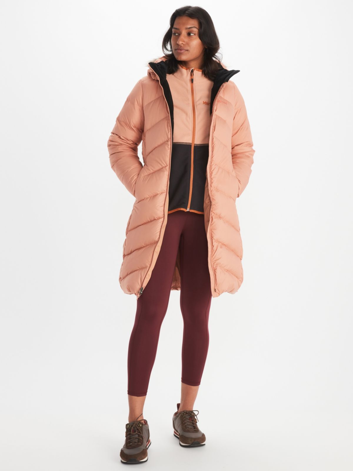 Woman in peach insulated coat with hood