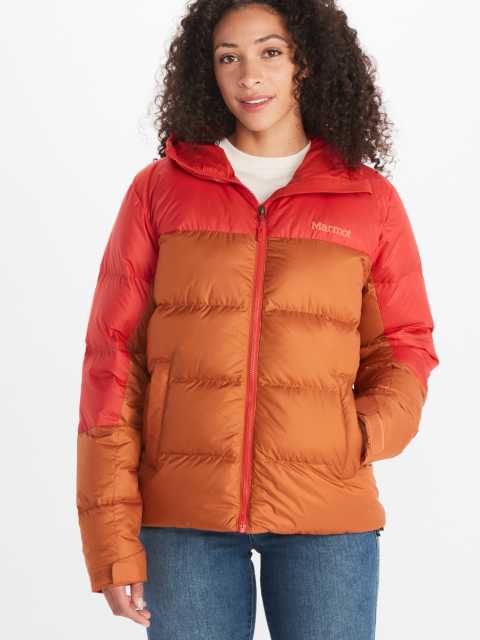 Model wearing Marmot women's insulated jacket in two toned orange and red short jacket