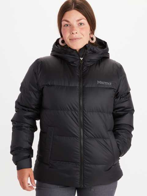 Model wearing Marmot women's insulated jacket in two toned orange and red short jacket