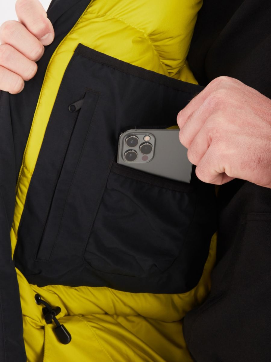 man putting phone into inside jacket pocket