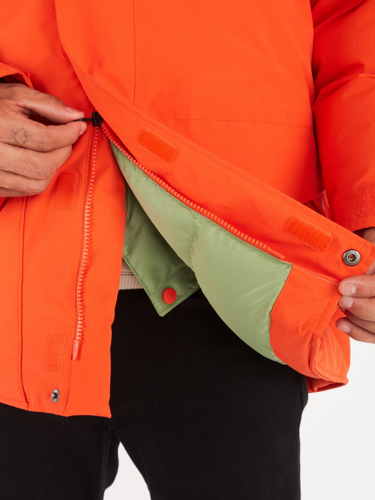 Person unzipping bottom portion of coat