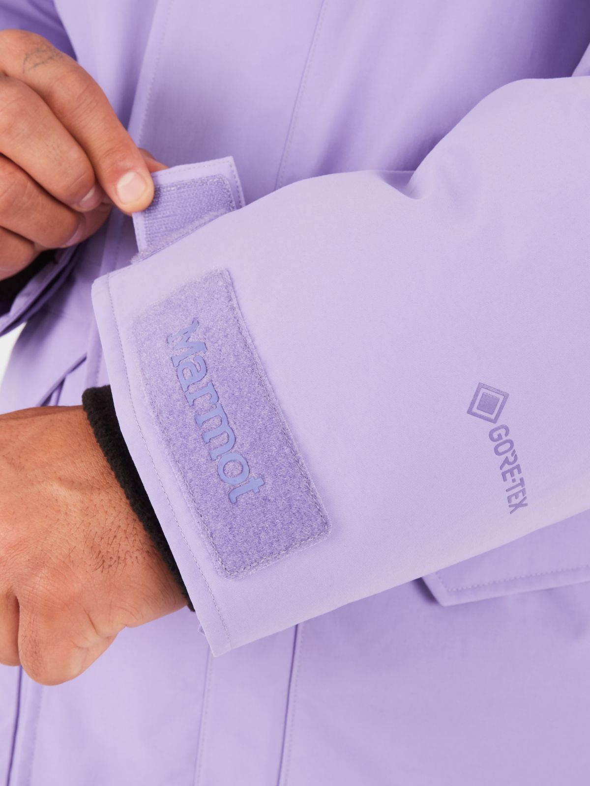 Man adjusting cuff of jacket