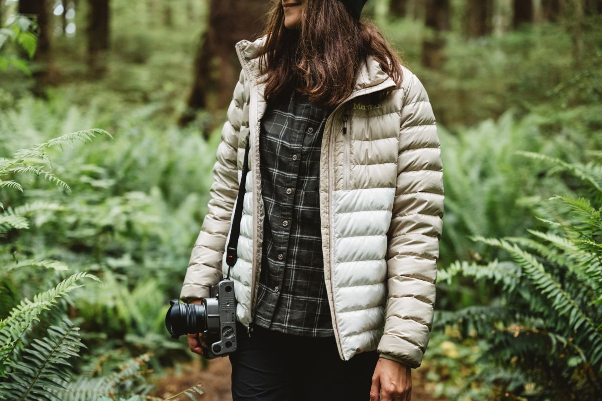 women wears marmot jacket in the forest