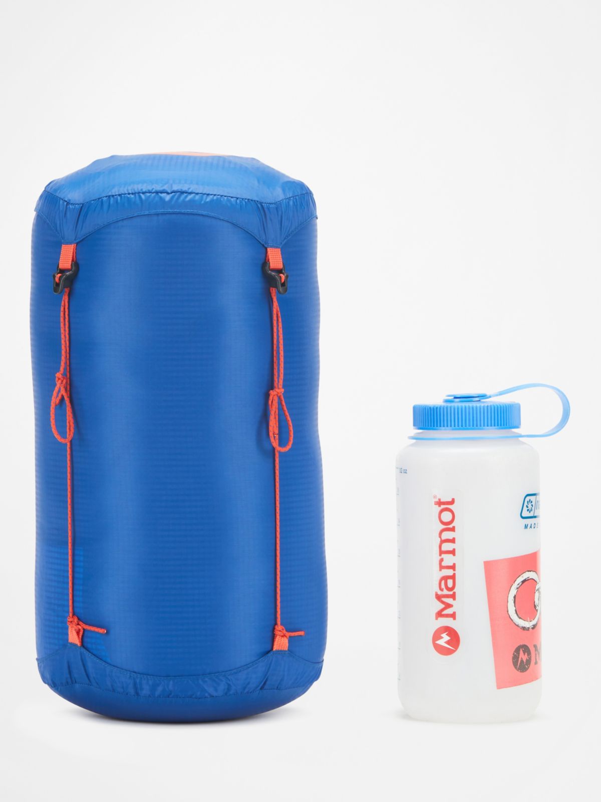 rolled up sleeping bag next to beverage container
