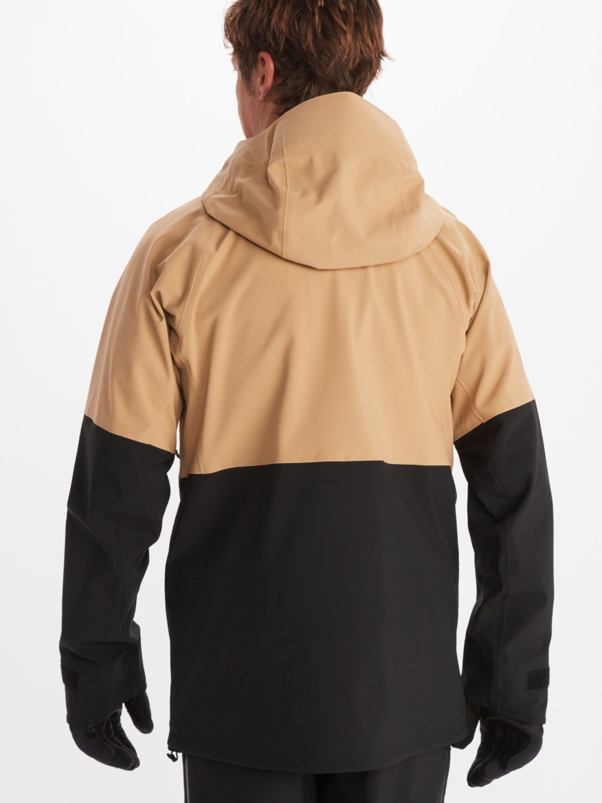 Model wearing two toned Marmot men's jacket in tan and black