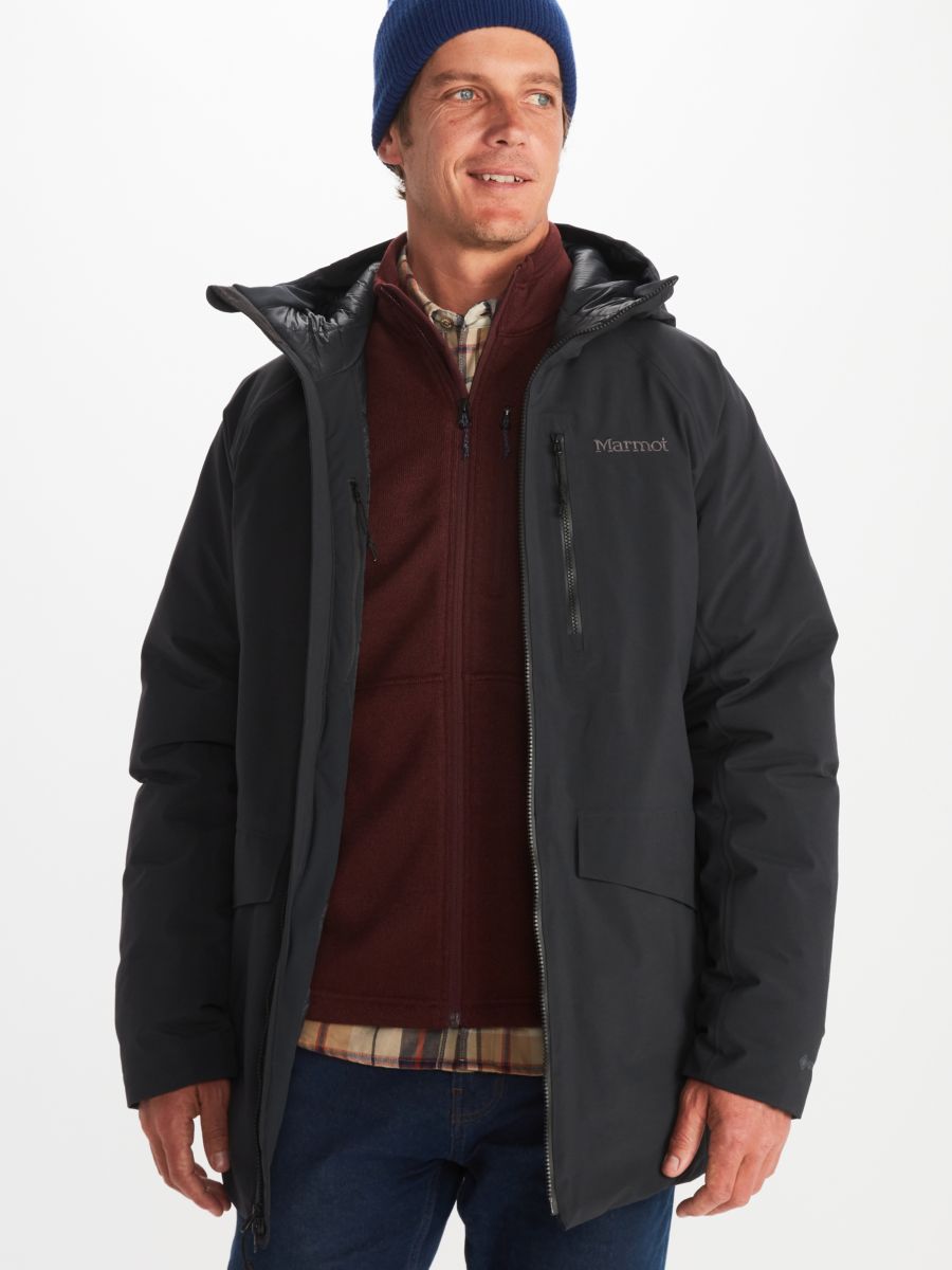 assorted male outdoor apparel worn by model