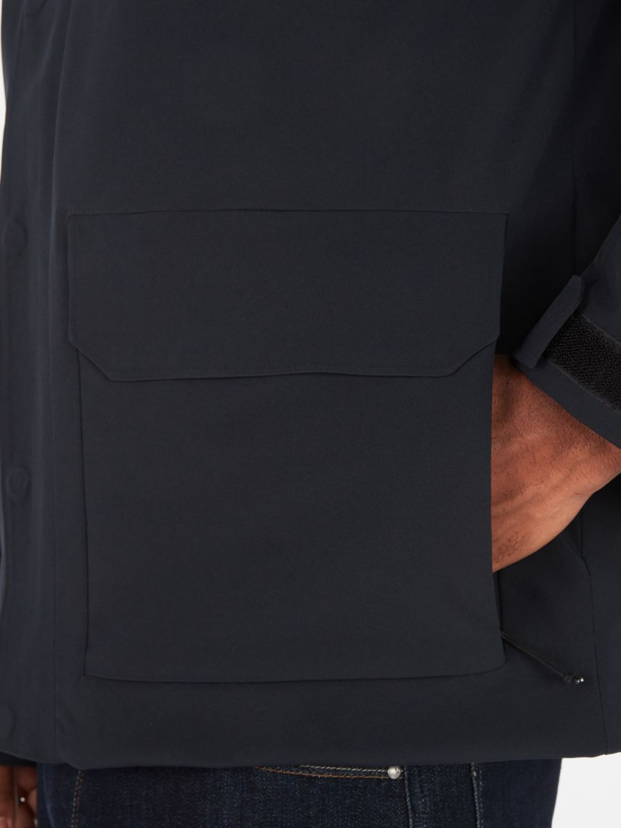 A hand in zipper pocket of men's jacket