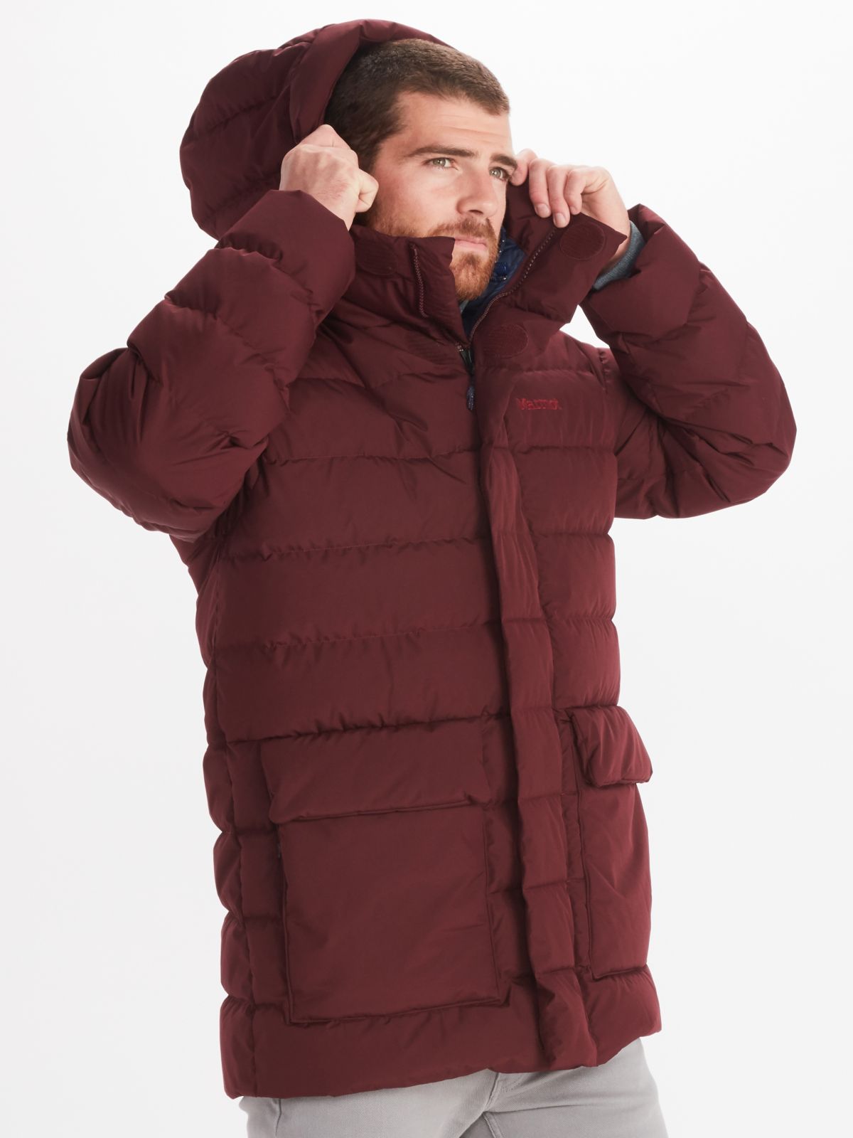 male model pulling up hoodie of winter jacket