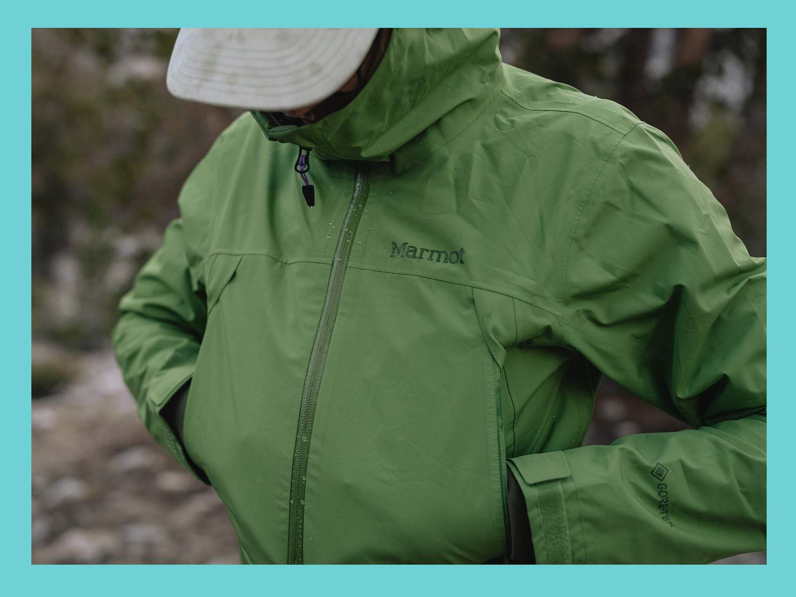 Hiker wearing Marmot green hooded jacket