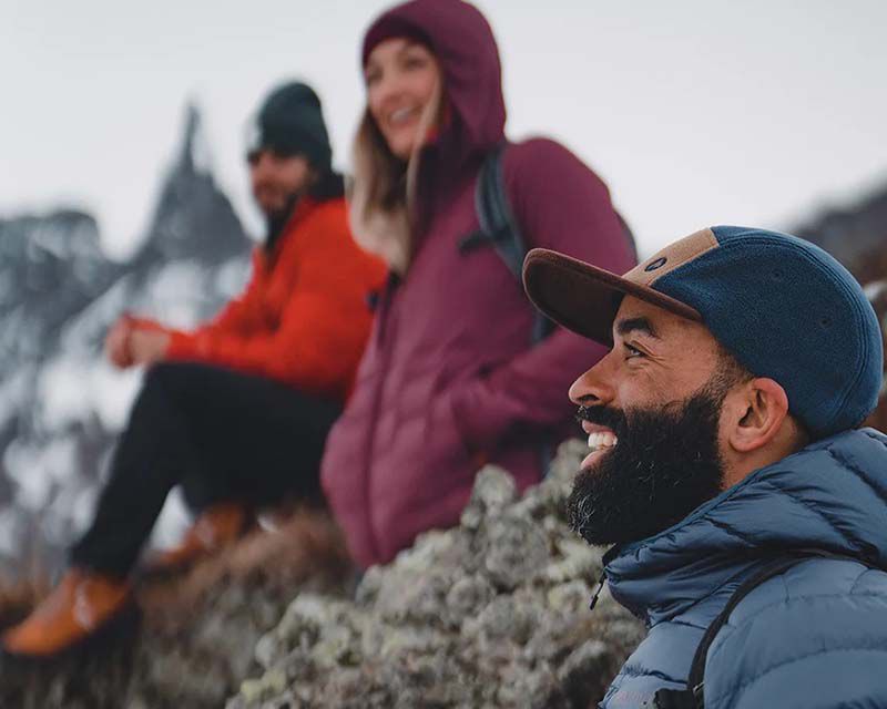 group of friends in outdoor clothing enjoying a hike through the mountains