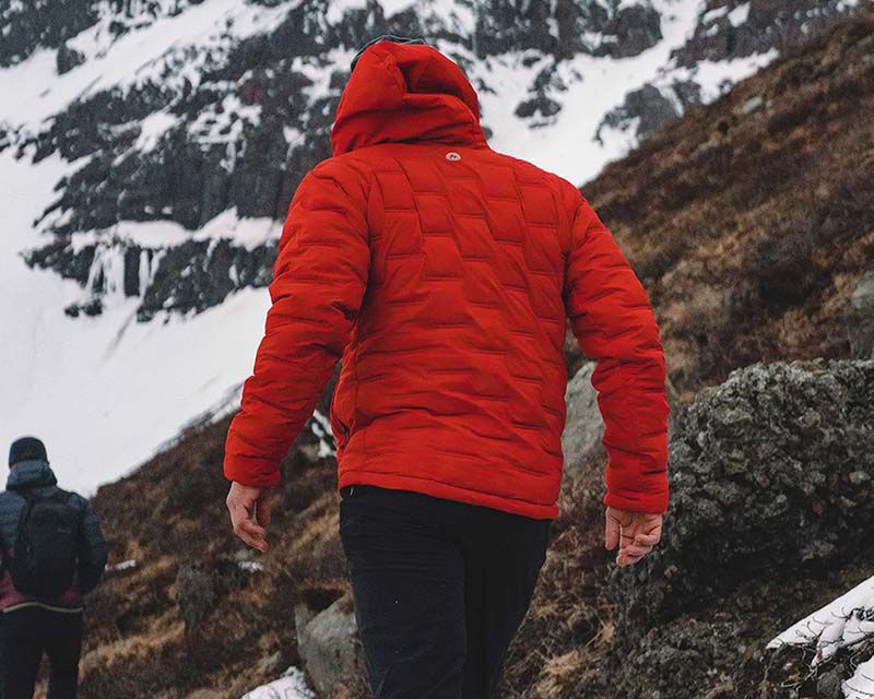 man in outdoor clothing enjoying a hike through the mountains