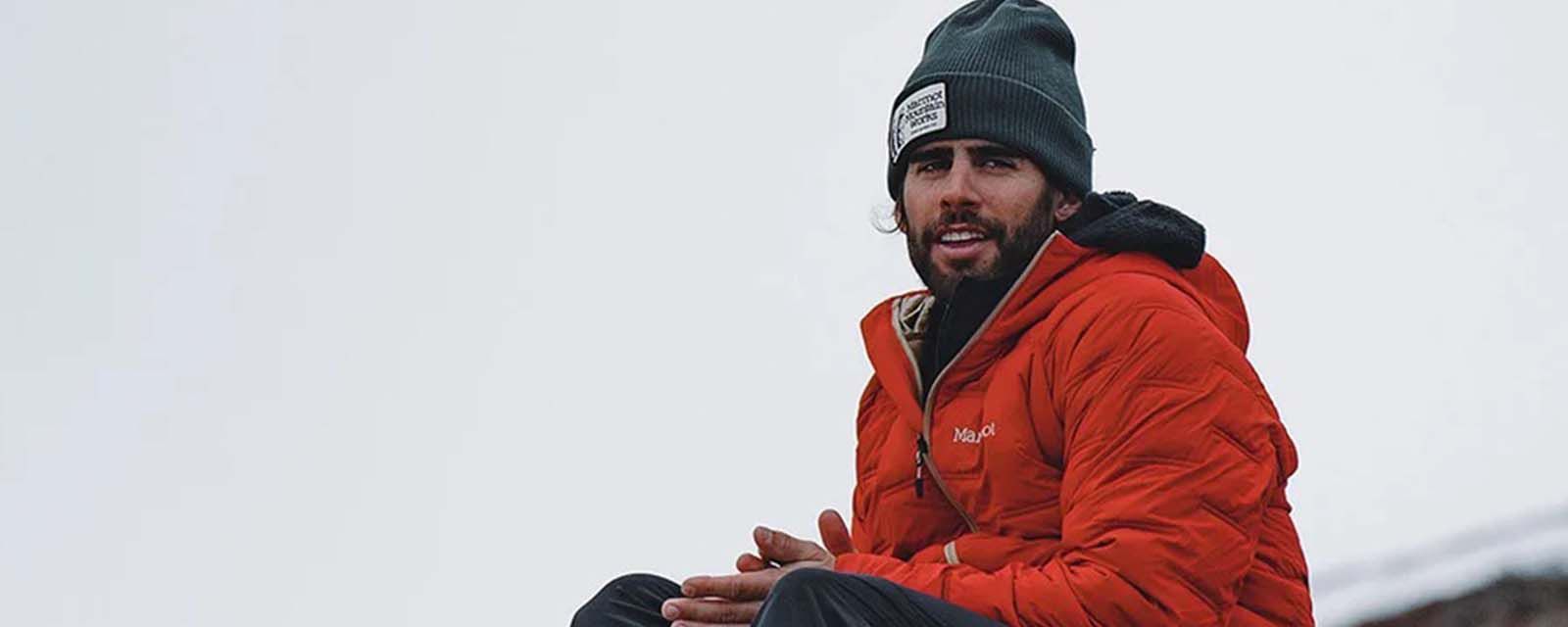 man in outdoor clothing enjoying a hike through the mountains