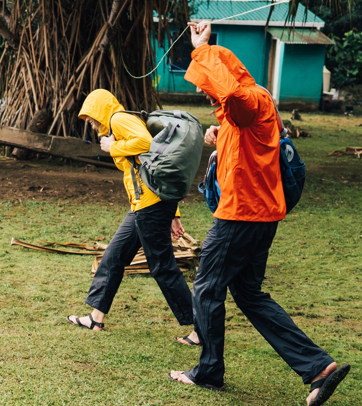 two people outside wearing yellow and orange rain coats