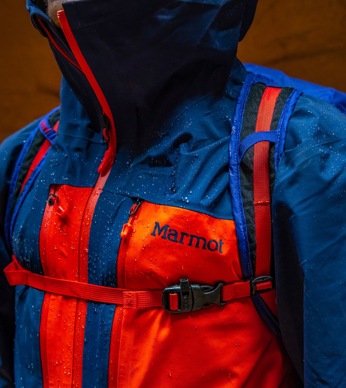 chest view of wet blue and orange rain jacket